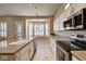 Bright kitchen boasts granite countertops, stainless appliances, tile floors and sunlit windows at 1574 Livingston Dr, Henderson, NV 89012