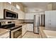 This kitchen showcases stainless appliances, granite counters, and ample cabinet space at 1574 Livingston Dr, Henderson, NV 89012
