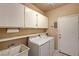 Laundry room featuring cabinets, a utility sink, and a newer washer and dryer at 1574 Livingston Dr, Henderson, NV 89012