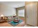 Comfortable living room featuring hardwood floors, a front door, and shuttered windows at 1574 Livingston Dr, Henderson, NV 89012