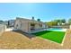 Spacious backyard featuring gravel landscaping, a grassy area, and a refreshing swimming pool under a clear sky at 1719 Rolling Hills Dr, Las Vegas, NV 89156