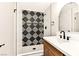 Modern bathroom featuring a stylish shower with black and white patterned tile and sleek fixtures at 1719 Rolling Hills Dr, Las Vegas, NV 89156