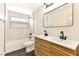 Contemporary bathroom featuring dual sinks, modern fixtures, and stylish herringbone tile flooring at 1719 Rolling Hills Dr, Las Vegas, NV 89156