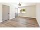 Bright bedroom with wood-look flooring, neutral walls, closet, and natural light from a window at 1719 Rolling Hills Dr, Las Vegas, NV 89156