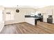 Open-concept kitchen featuring white cabinets, a breakfast bar, and modern stainless steel appliances at 1719 Rolling Hills Dr, Las Vegas, NV 89156