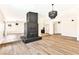 Open-concept living room highlights a modern brick fireplace, wood-look flooring, and contemporary light fixtures at 1719 Rolling Hills Dr, Las Vegas, NV 89156