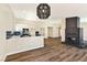 Bright living space boasts sleek wood flooring, modern lighting, a cozy fireplace, and seamless flow to the kitchen at 1719 Rolling Hills Dr, Las Vegas, NV 89156