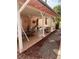 View of covered back patio featuring tile flooring and comfortable seating area with mature landscaping at 1853 Citroen St, Las Vegas, NV 89142
