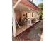 View of covered back patio featuring tile flooring and comfortable seating area with mature landscaping at 1853 Citroen St, Las Vegas, NV 89142