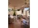 View of back patio with ceiling fans, tile flooring, wicker seating area, and desert landscaping at 1853 Citroen St, Las Vegas, NV 89142