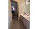 Bathroom with dual sinks, cabinets, and view to bedroom through doorway at 1853 Citroen St, Las Vegas, NV 89142