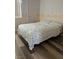 Bedroom with floral bedding, patterned wallpaper, and wood laminate flooring at 1853 Citroen St, Las Vegas, NV 89142