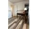 Bedroom featuring laminate floors, desk, chair, closet and patterned wallpaper at 1853 Citroen St, Las Vegas, NV 89142