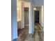 Hallway with wood-look floors leading to a bathroom and other rooms at 1853 Citroen St, Las Vegas, NV 89142