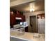 Kitchen with wood cabinets, white countertops, white appliances and a breakfast bar at 1853 Citroen St, Las Vegas, NV 89142