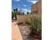 View of the side yard area with walkway, mature landscaping, rock garden, and privacy wall at 1853 Citroen St, Las Vegas, NV 89142