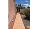 View down tiled walkway of the side yard area with mature landscaping and rock garden at 1853 Citroen St, Las Vegas, NV 89142