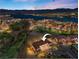 Stunning aerial view of a luxury home in a lakeside community with a golf course and mountain views at 20 Via Visione # 105, Henderson, NV 89011