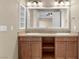 Bright bathroom featuring double sinks, granite countertops, and dark wood cabinetry at 20 Via Visione # 105, Henderson, NV 89011