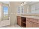 Bathroom features a double sink vanity, a large mirror, and a separate bath area with a view at 20 Via Visione # 105, Henderson, NV 89011