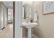 Elegant bathroom features a pedestal sink, framed mirror, and neutral color palette at 20 Via Visione # 105, Henderson, NV 89011
