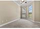 Neutral bedroom with carpet, and two windows with an view of trees and architecture at 20 Via Visione # 105, Henderson, NV 89011