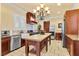 Gourmet kitchen with stainless steel appliances, island, and custom cabinetry at 20 Via Visione # 105, Henderson, NV 89011