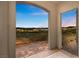 Picturesque view of Lake Las Vegas at sunset, framed by an arched entryway and lush greenery at 20 Via Visione # 105, Henderson, NV 89011