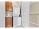 Functional laundry area with stacked washer and dryer, overhead cabinet, and storage at 20 Via Visione # 105, Henderson, NV 89011