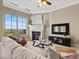 Comfortable living room with a fireplace, plush sofa, and large windows that offer scenic views and natural light at 20 Via Visione # 105, Henderson, NV 89011