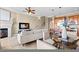 Open-concept living space featuring a fireplace, kitchen bar, and a dining area perfect for gatherings and relaxation at 20 Via Visione # 105, Henderson, NV 89011