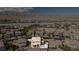High-angle aerial view displaying the back of the home with a pristine pool, patio, and lush greenery at 2021 Royal Gardens Pl, North Las Vegas, NV 89084