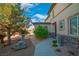 Charming backyard featuring a well maintained yard with palm trees and other landscaping, and stone columns with a fountain at 2021 Royal Gardens Pl, North Las Vegas, NV 89084