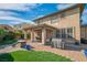 Charming backyard with patio, grill, seating area, and lush landscaping at 2021 Royal Gardens Pl, North Las Vegas, NV 89084