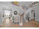 Spacious entryway with curved staircase, decorative mirror, and tiled flooring at 2021 Royal Gardens Pl, North Las Vegas, NV 89084