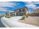 Stunning two-story home featuring a stone facade, a three-car garage, and a well-maintained, xeriscaped front yard at 2021 Royal Gardens Pl, North Las Vegas, NV 89084
