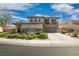 Inviting two-story home with manicured landscaping, a stone facade, and a convenient two-car garage at 2021 Royal Gardens Pl, North Las Vegas, NV 89084