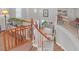 Second story hallway featuring decorative railings, neutral tones, and overlooking the entry at 2021 Royal Gardens Pl, North Las Vegas, NV 89084