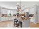 Bright kitchen featuring white cabinets, granite countertops, stainless steel appliances, and an island with seating at 2021 Royal Gardens Pl, North Las Vegas, NV 89084