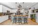 Stylish kitchen featuring white cabinets, granite countertops, tile backsplash and large kitchen island at 2021 Royal Gardens Pl, North Las Vegas, NV 89084