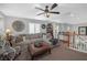 Inviting living room with neutral tones, comfortable seating, a ceiling fan, and bright natural light at 2021 Royal Gardens Pl, North Las Vegas, NV 89084