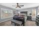 Comfortable bedroom features carpet floors, fan, plantation shutters, a large comfortable bed, and modern furniture at 2021 Royal Gardens Pl, North Las Vegas, NV 89084