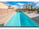 Relaxing backyard includes a swimming pool, lounge chair, and privacy wall at 2021 Royal Gardens Pl, North Las Vegas, NV 89084
