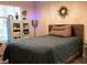 Well-decorated bedroom with soft lighting, comfy bed, display cabinet, and accent pieces at 2050 W Warm Springs Rd # 411, Henderson, NV 89014