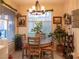 Cozy dining room with a round wooden table, natural light, and comfortable seating at 2050 W Warm Springs Rd # 411, Henderson, NV 89014