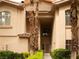 A tan stucco home with beautiful landscaping and a tile roof at 2050 W Warm Springs Rd # 411, Henderson, NV 89014