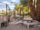 Community grill area with a grill, benches, tables, and palm trees at 2050 W Warm Springs Rd # 411, Henderson, NV 89014
