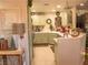 Charming kitchen featuring green cabinets, stainless appliances, and modern lighting fixtures at 2050 W Warm Springs Rd # 411, Henderson, NV 89014