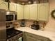 Stylish kitchen with green cabinetry, stainless steel appliances, and modern countertops at 2050 W Warm Springs Rd # 411, Henderson, NV 89014
