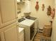 Functional laundry room featuring modern washer, dryer, storage cabinets and decorative dolls at 2050 W Warm Springs Rd # 411, Henderson, NV 89014